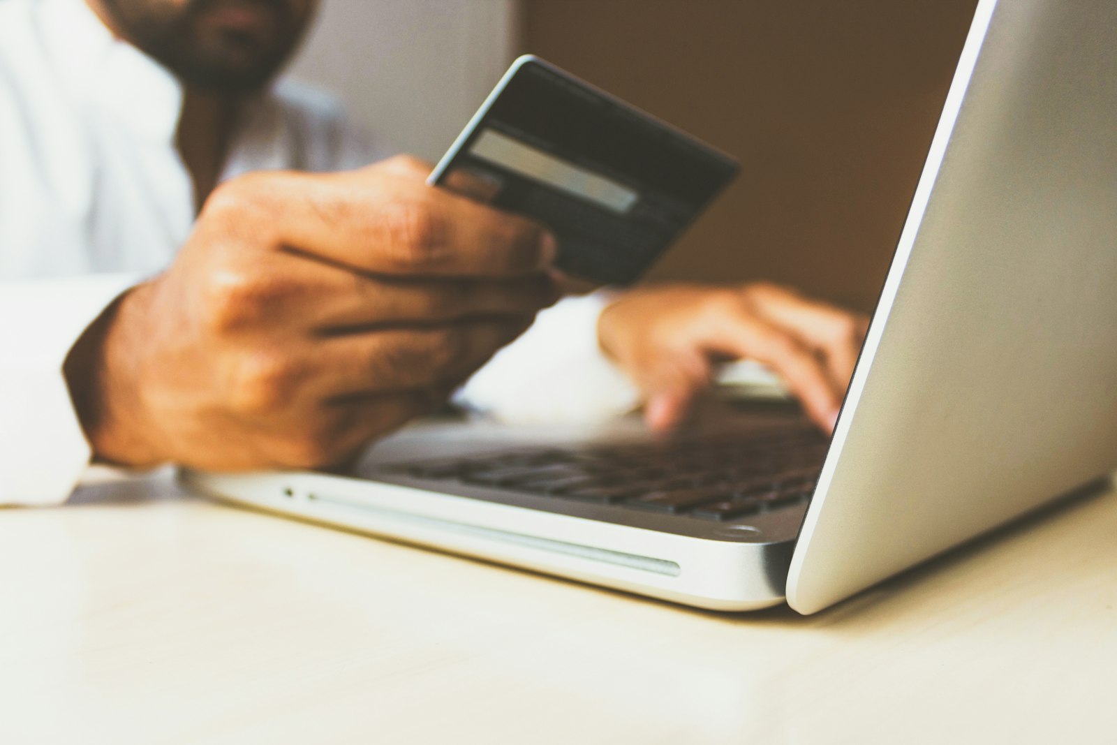 Laptop and payment card representing ecommerce payment security checks