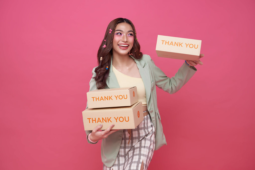 Ecommerce business owner holding shipping boxes for B2B order fulfillment