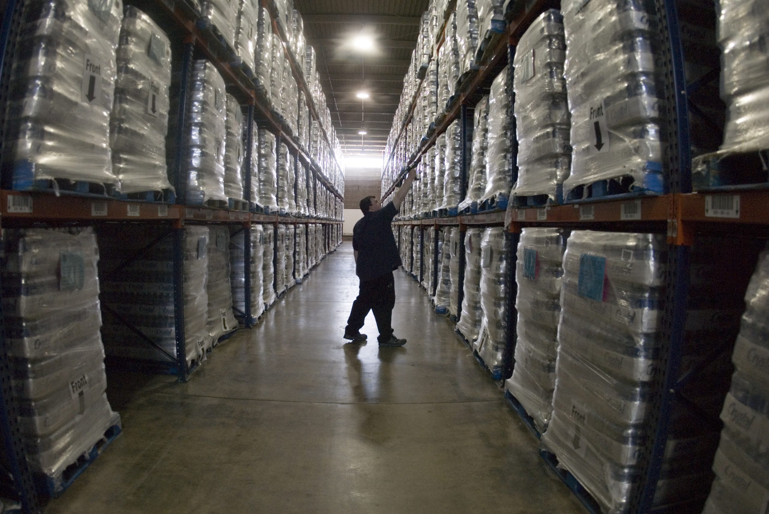 Warehouse employee scanning inventory with a barcode scanner for ecommerce operations