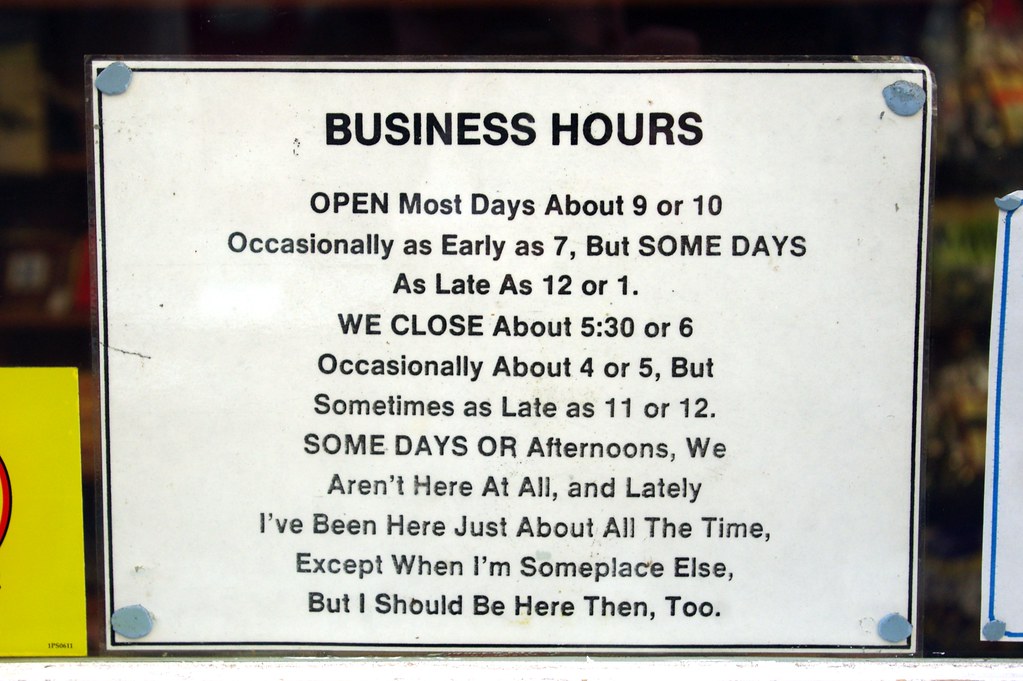 Handwritten business hours sign displayed at a local shop