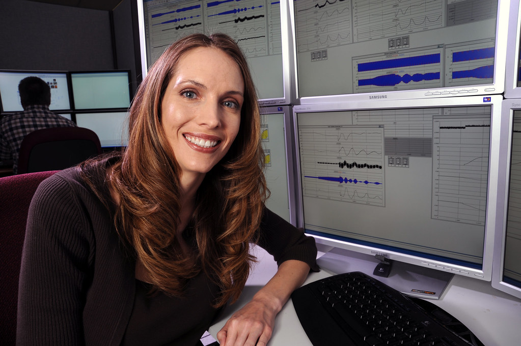 Cybersecurity specialist reviewing website security alerts at a computer workstation