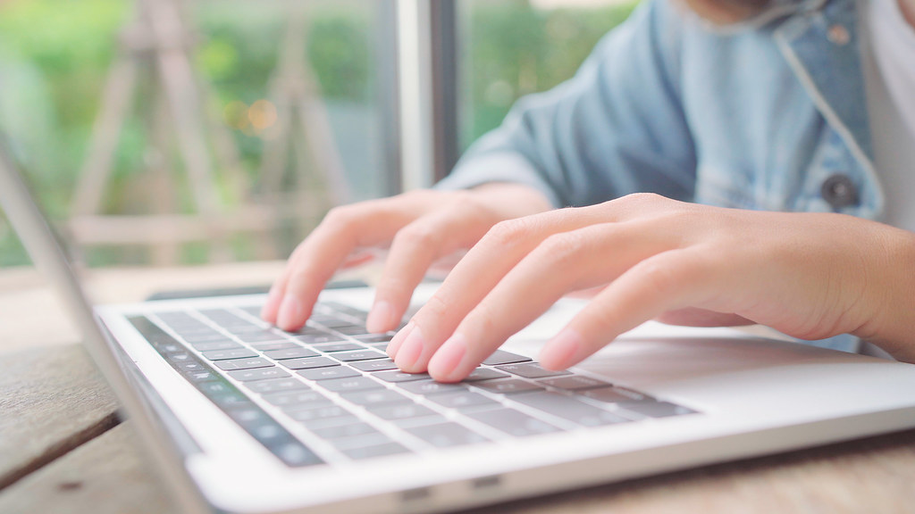 Business owner reviewing ecommerce recovery emails on a laptop