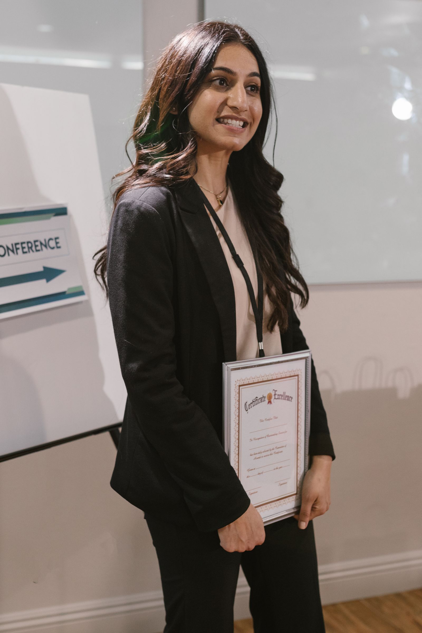 Business professional holding a framed certificate, representing verifiable business credentials