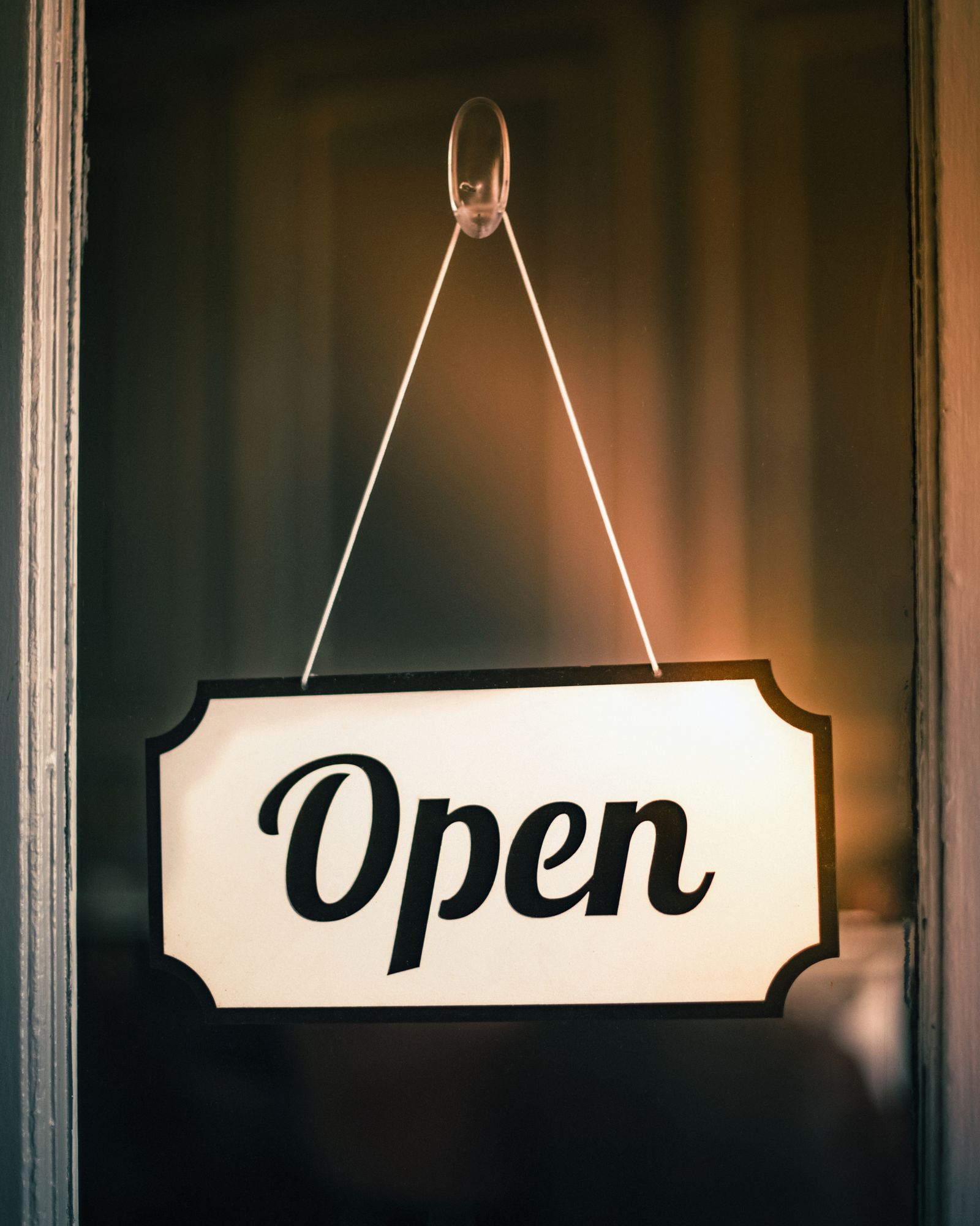 Vintage open sign hanging on a shop door