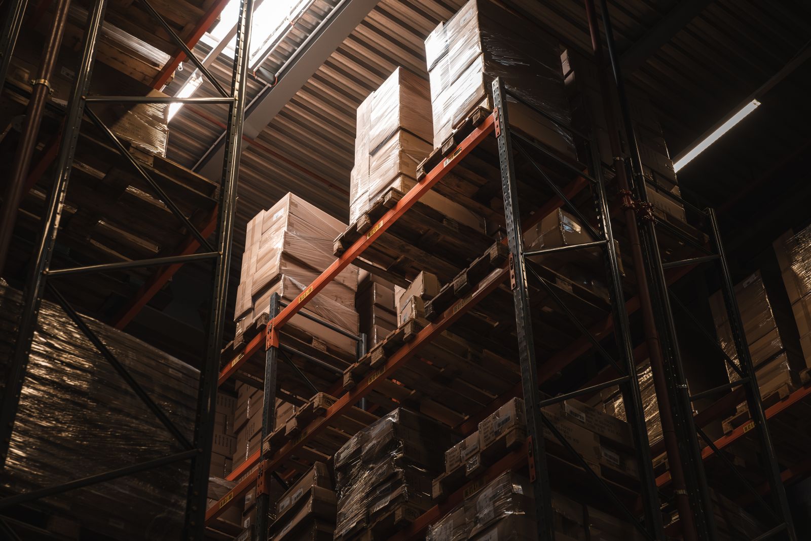 Cardboard boxes stored on tall warehouse shelves